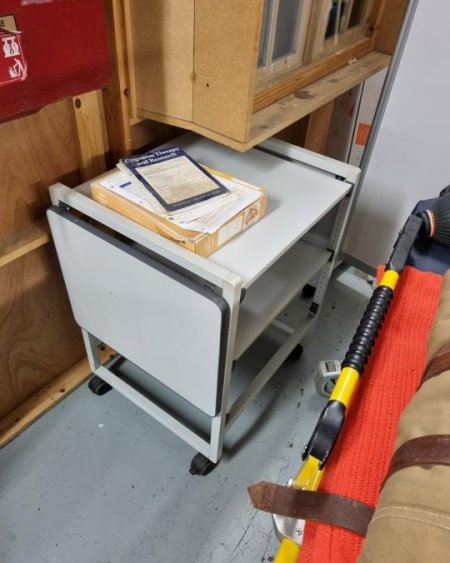 Grey medical trolley with extendable shelf 