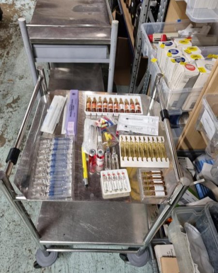 Various vials , epi pen, water solution packages