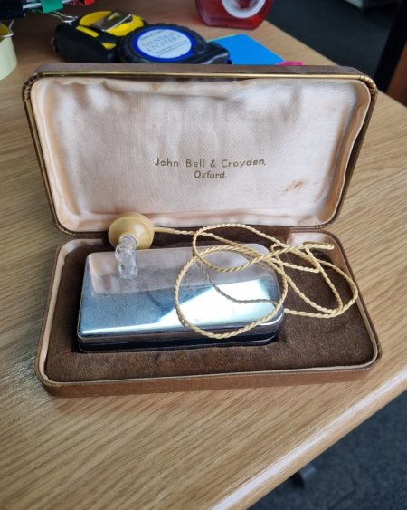 Hearing aid with loop in brown case